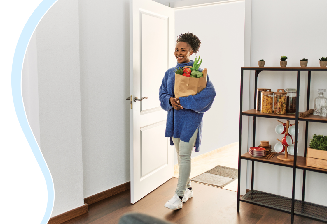 Female walking into a room with groceries; not an actual patient